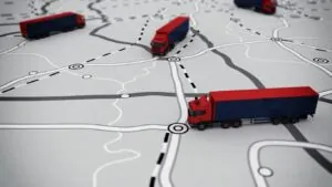 Transportadora de móveis para outro estado: miniaturas de caminhões de mudança em cima de mapa.